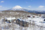 Nestled in a snowy landscape, this stunning property offers breathtaking views of a snow-capped volcano.