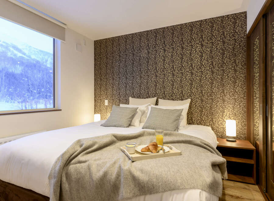 Wake up to breathtaking mountain views from this cozy bedroom.