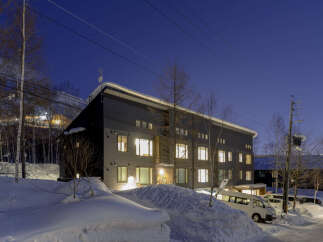This stunning modern building is nestled in a snowy landscape, offering breathtaking views.