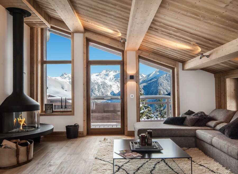 Luxury chalet with breathtaking mountain views and a modern fireplace.