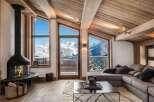 Luxury chalet with breathtaking mountain views and a modern fireplace.
