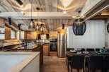 This stunning chalet boasts a spacious, open-plan kitchen with high-end appliances and custom wooden cabinetry.