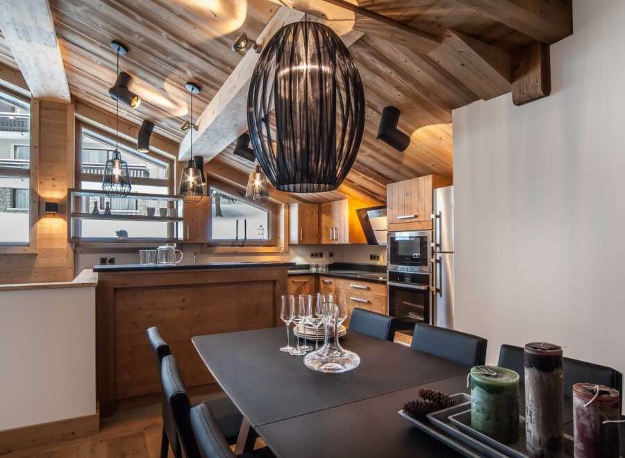 This stunning chalet boasts a spacious open-plan kitchen and dining area, perfect for entertaining guests.