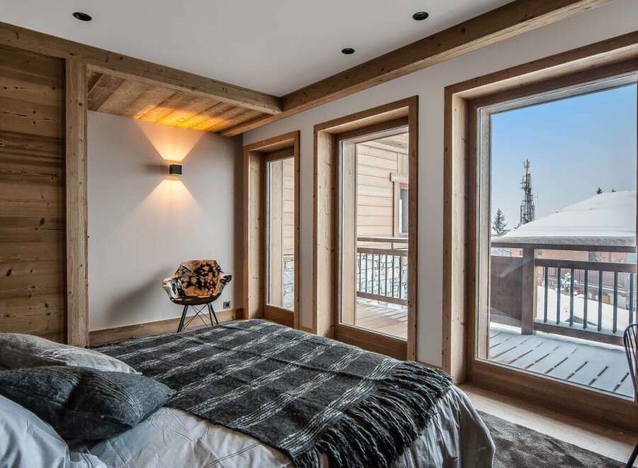 Luxurious chalet bedroom with stunning mountain views.