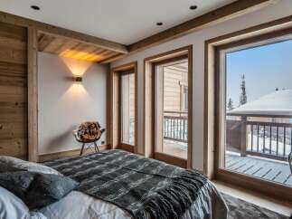 Luxurious chalet bedroom with stunning mountain views.