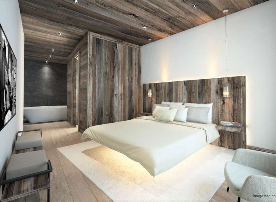 Experience luxurious mountain living in this stunning bedroom, featuring a floating bed and a spa-like ensuite bathroom.