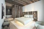 Experience luxurious mountain living in this stunning bedroom, featuring a floating bed and a spa-like ensuite bathroom.