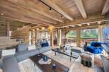 Luxury chalet with stunning mountain views and spacious open-plan living area.