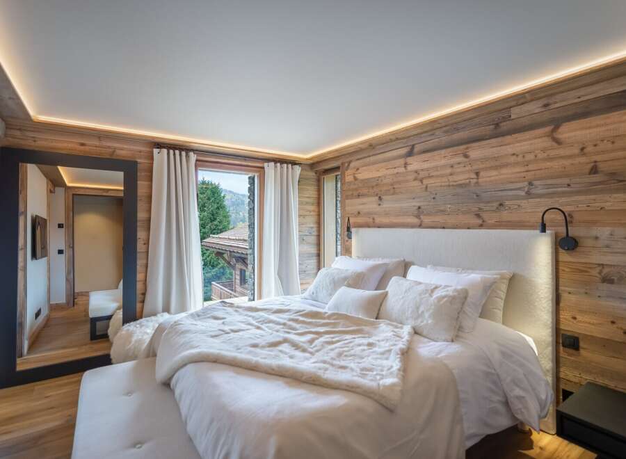 Luxurious chalet bedroom with stunning mountain views.