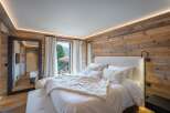 Luxurious chalet bedroom with stunning mountain views.