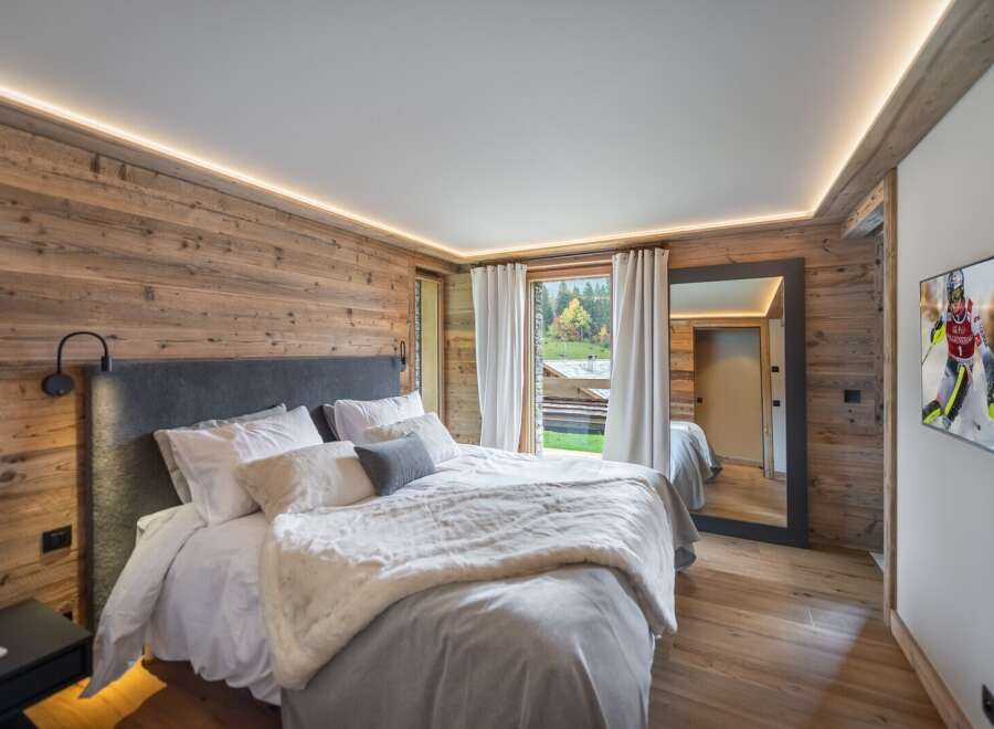 Luxurious chalet bedroom with stunning mountain views.