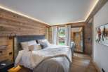 Luxurious chalet bedroom with stunning mountain views.