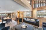 This stunning chalet boasts an open-plan living area with floor-to-ceiling windows offering breathtaking views.