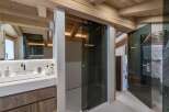 This luxurious bathroom boasts a stunning walk-in shower with a sleek, modern glass enclosure and a heated towel rack for added comfort.