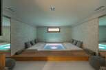 Indulge in ultimate relaxation in this stunning home spa, featuring a built-in hot tub and plush seating.