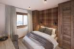 Cozy mountain chalet bedroom with stunning views.