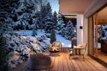 Cozy up by the fire pit on this stunning snow-covered deck, complete with comfortable seating and breathtaking mountain views.
