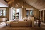 Luxurious chalet bedroom with stunning mountain views and a cozy atmosphere.