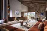 This stunning chalet boasts a spacious open-plan living area with a cozy fireplace, perfect for relaxing after a day on the slopes.