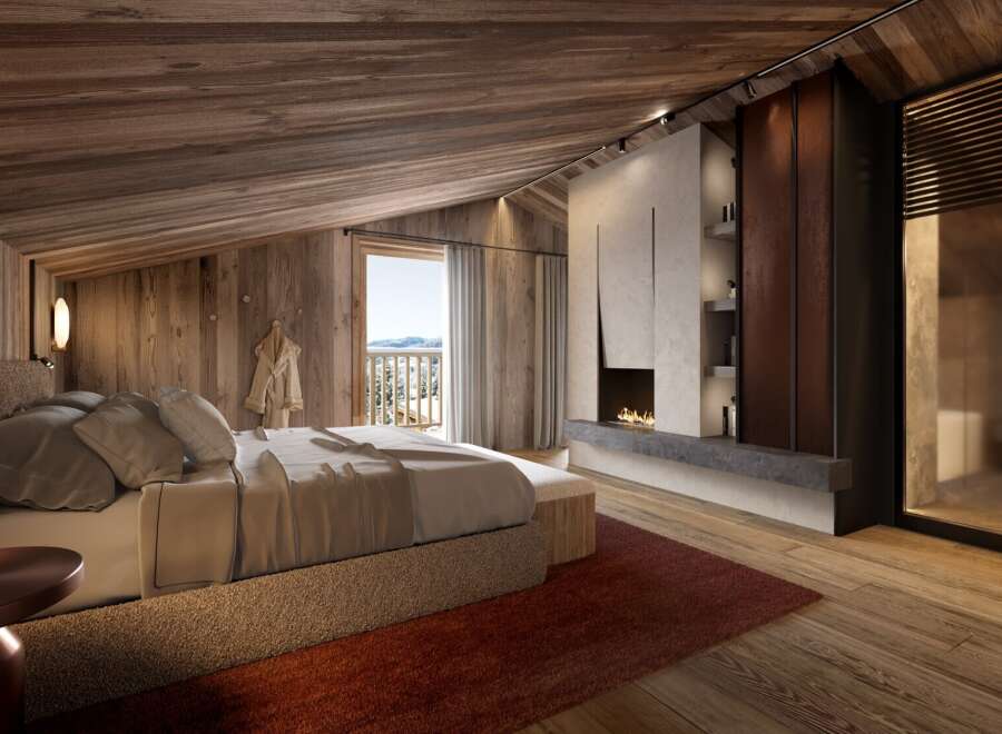 Luxurious chalet bedroom with stunning mountain views and a cozy fireplace.