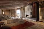 Luxurious chalet bedroom with stunning mountain views and a cozy fireplace.