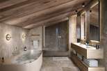 Luxurious bathroom with a freestanding tub and double vanity, showcasing a stunning blend of natural wood and marble.