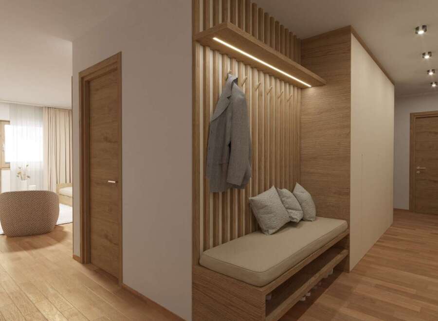 Step into a beautifully designed entryway with warm wooden accents and a welcoming bench.