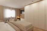 This bedroom boasts a modern design with a neutral color palette, creating a serene and inviting atmosphere.