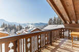 Enjoy breathtaking mountain views from this charming chalet balcony.