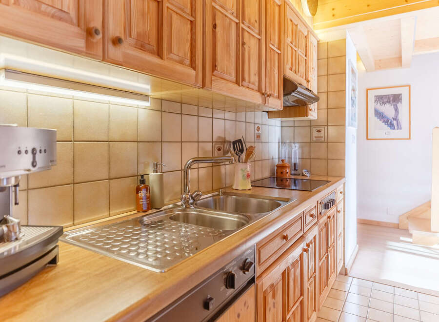 This charming kitchen boasts warm wooden cabinetry and a functional layout.
