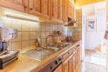This charming kitchen boasts warm wooden cabinetry and a functional layout.