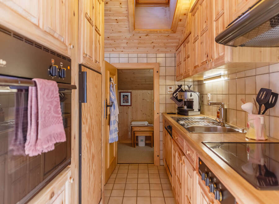 Cozy kitchen with wooden cabinets and a modern stove.