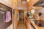 Cozy kitchen with wooden cabinets and a modern stove.