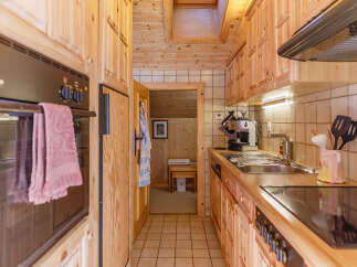 Cozy kitchen with wooden cabinets and a modern stove.