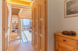 Discover the charm of this inviting home, featuring a warm wooden interior and a stunning staircase.