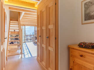 Discover the charm of this inviting home, featuring a warm wooden interior and a stunning staircase.