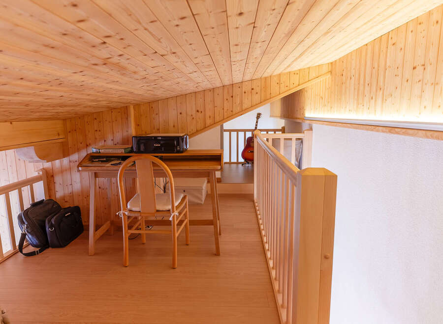 Discover the charm of this cozy loft space, featuring warm wooden accents and a bright, inviting atmosphere.