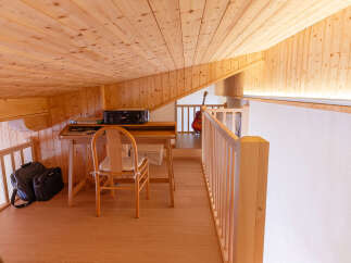 Discover the charm of this cozy loft space, featuring warm wooden accents and a bright, inviting atmosphere.