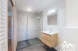 Discover this modern bathroom featuring a sleek glass shower enclosure and stylish floating vanity.