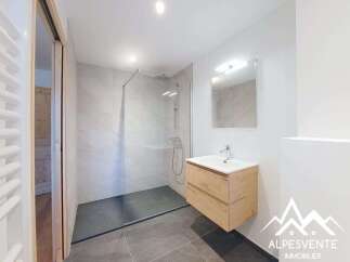 Discover this modern bathroom featuring a sleek glass shower enclosure and stylish floating vanity.