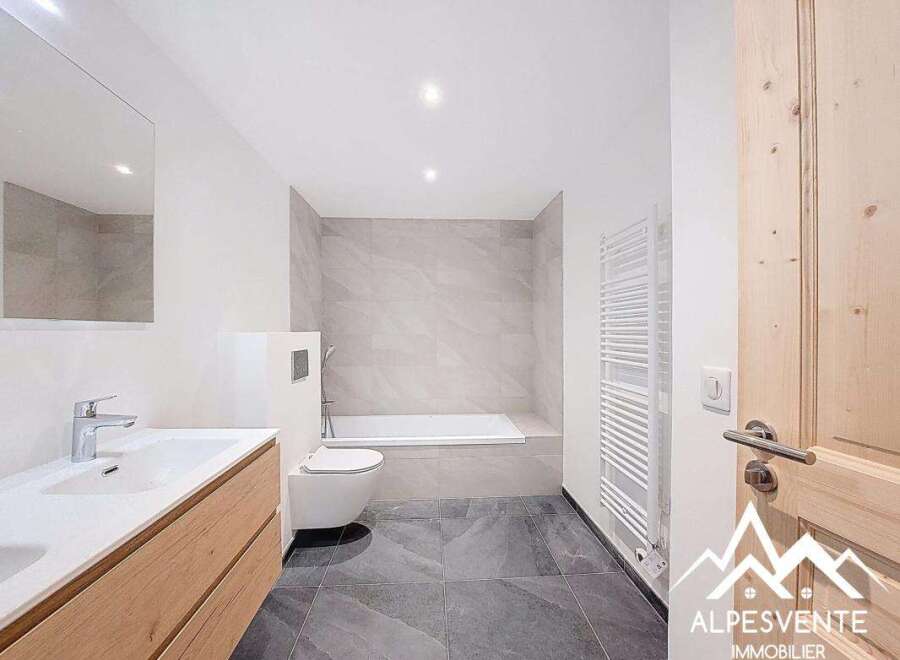 This modern bathroom features a sleek design with a combination of light and dark tones.