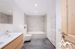 This modern bathroom features a sleek design with a combination of light and dark tones.