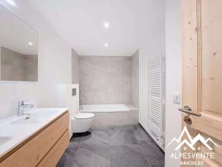 This modern bathroom features a sleek design with a combination of light and dark tones.