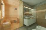 Experience ultimate relaxation in this luxurious bathroom featuring a modern sauna.