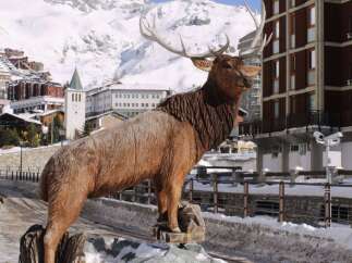 Discover the charm of this property, featuring a stunning wooden elk sculpture as a focal point.