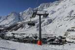 Enjoy breathtaking mountain views and a thrilling ski lift ride in this stunning winter landscape.