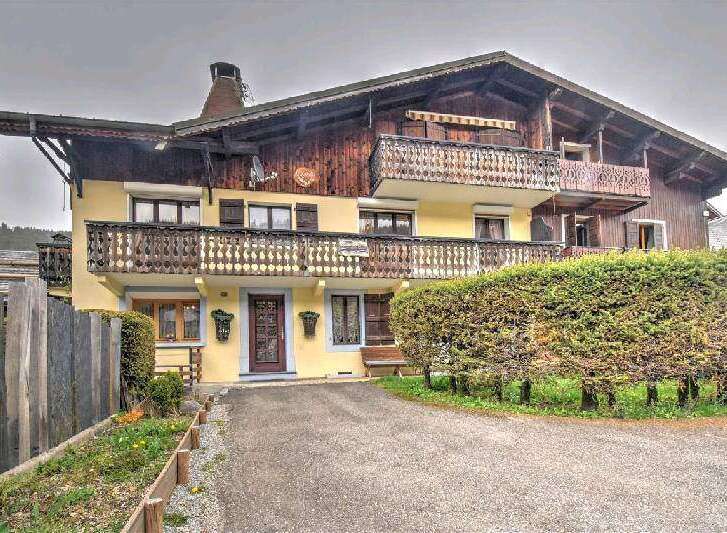 Charming chalet-style home nestled in a picturesque setting.