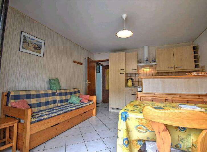 Cozy apartment featuring a comfortable wooden sofa bed, perfect for relaxation.