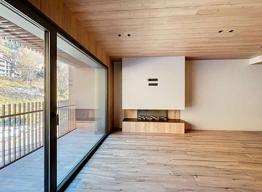 Experience luxury living in this stunning property, featuring a modern design with a cozy fireplace and expansive windows.