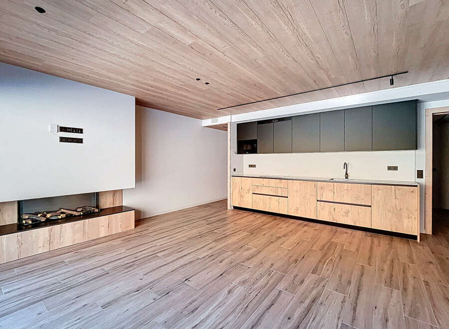 Experience modern luxury in this stunning property, featuring a sleek kitchen with custom cabinetry and high-end appliances.